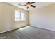 Bright bedroom with window, ceiling fan and cozy carpet at 2129 E Yuma Ave, Apache Junction, AZ 85119