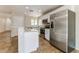 Modern kitchen with stainless steel appliances, white cabinetry, and a breakfast bar at 2129 E Yuma Ave, Apache Junction, AZ 85119