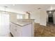 Kitchen with granite countertops, white cabinetry, and views to the living area at 2129 E Yuma Ave, Apache Junction, AZ 85119
