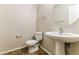 A powder room with tile flooring, pedestal sink, and modern fixtures at 2129 E Yuma Ave, Apache Junction, AZ 85119