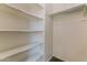 Spacious walk-in closet with multiple shelves and hanging rod at 2129 E Yuma Ave, Apache Junction, AZ 85119
