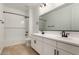 Modern bathroom featuring double sinks, quartz countertops, and a shower-tub combo at 21348 N Belt Dr, Maricopa, AZ 85138