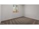 Bedroom featuring carpet floors and white walls, accented by a sunny window at 21348 N Belt Dr, Maricopa, AZ 85138