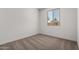 Carpeted bedroom featuring natural light from a large window at 21348 N Belt Dr, Maricopa, AZ 85138