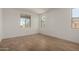 Neutral bedroom with wood-look flooring and a series of windows, providing natural light at 21348 N Belt Dr, Maricopa, AZ 85138