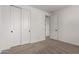 Bright bedroom with carpet, closet, and door to another room at 21348 N Belt Dr, Maricopa, AZ 85138