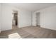 A bedroom featuring neutral carpet, white walls, and an open door to the bathroom at 21348 N Belt Dr, Maricopa, AZ 85138