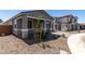 Single-story home with stone landscaping and modern gray paint at 21348 N Belt Dr, Maricopa, AZ 85138