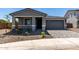 Inviting single-Gathering home featuring a well-manicured lawn and an attached two-car garage and a paver driveway at 21348 N Belt Dr, Maricopa, AZ 85138