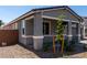Single-story home with stone landscaping and modern gray paint at 21348 N Belt Dr, Maricopa, AZ 85138