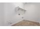 A simple laundry room with modern tile and a shelf for storage at 21348 N Belt Dr, Maricopa, AZ 85138