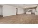 Spacious living area with tile flooring, white walls, and an open concept floor plan with bright natural lighting at 21348 N Belt Dr, Maricopa, AZ 85138
