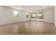 Expansive living room with tile floors, white walls, large sliding glass doors, and ample natural light at 21348 N Belt Dr, Maricopa, AZ 85138