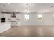 Open concept living room with tile floors featuring a view of the kitchen, dining area, and backyard at 21348 N Belt Dr, Maricopa, AZ 85138