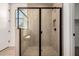 Modern walk-in shower featuring a glass enclosure, tiled walls, and sleek fixtures at 21348 N Belt Dr, Maricopa, AZ 85138