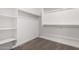 A walk-in closet with built-in shelving and hanging rods, providing ample storage space at 21348 N Belt Dr, Maricopa, AZ 85138