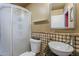 Compact bathroom with tiled accents, a vessel sink, and a glass-enclosed shower at 2202 W Enid Ave, Mesa, AZ 85202