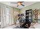 Green home office featuring a desk setup, shelving, and natural lighting at 2202 W Enid Ave, Mesa, AZ 85202