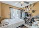 Neutral bedroom with sliding glass door and a cluttered shelving unit/entertainment center at 2202 W Enid Ave, Mesa, AZ 85202