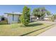 Pleasant exterior view of a well-maintained lawn and mature tree, creating a serene and welcoming environment at 2202 W Enid Ave, Mesa, AZ 85202