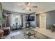 Modern living room with a large TV, hardwood floors, and comfortable furniture, perfect for relaxation and entertainment at 2202 W Enid Ave, Mesa, AZ 85202