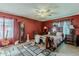 Cozy main bedroom features dark red walls, antique furnishings, and neutral carpet at 2202 W Enid Ave, Mesa, AZ 85202