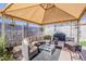 Cozy covered patio with comfortable seating, a ceiling, and a grill, perfect for outdoor relaxation and entertaining at 2202 W Enid Ave, Mesa, AZ 85202