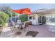 Backyard patio with outdoor seating, red umbrella, and partial shade at 2202 W Enid Ave, Mesa, AZ 85202