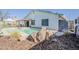 A backyard pool area with rock features and desert landscaping at 2202 W Enid Ave, Mesa, AZ 85202