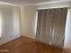 Empty bedroom featuring durable laminate floors, neutral paint, and standard closet at 235 W Southern Ave # 150, Mesa, AZ 85210