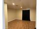 Well-lit bedroom with wood laminate flooring and window with black out curtains at 235 W Southern Ave # 150, Mesa, AZ 85210