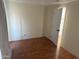 Bedroom with durable laminate flooring, standard closet, and open white door at 235 W Southern Ave # 150, Mesa, AZ 85210