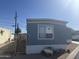 Exterior of a single Gathering home featuring blue paint and white trim at 235 W Southern Ave # 150, Mesa, AZ 85210