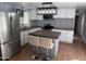 Modern kitchen features stainless steel appliances, white cabinets, and eat-in island at 235 W Southern Ave # 150, Mesa, AZ 85210