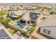 Expansive aerial view showcasing a private backyard oasis with a pool, patio, and solar panels on the roof of a home at 24638 N 144Th Ave, Surprise, AZ 85387