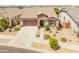 Beautiful aerial view of a single-story home with a well-manicured front yard and inviting curb appeal in a quiet neighborhood at 24638 N 144Th Ave, Surprise, AZ 85387