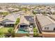 Aerial view of home showcasing the backyard pool, patio, and solar panels in a Gathering-friendly community at 24638 N 144Th Ave, Surprise, AZ 85387