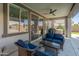 Inviting covered patio features stylish seating and a scenic view of the pool and outdoor space at 24638 N 144Th Ave, Surprise, AZ 85387