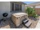 Backyard hot tub and BBQ area with well-maintained landscaping, ideal for relaxation and outdoor cooking at 24638 N 144Th Ave, Surprise, AZ 85387