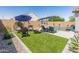 Well-maintained backyard features a pool, artificial turf, and stylish patio furniture for outdoor enjoyment at 24638 N 144Th Ave, Surprise, AZ 85387
