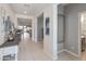 Inviting hallway features neutral tones, elegant decor, and a clear view towards the living area and backyard at 24638 N 144Th Ave, Surprise, AZ 85387