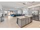 Open-concept kitchen with a center island, stainless steel appliances, and seamless view to living area at 24638 N 144Th Ave, Surprise, AZ 85387