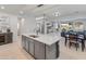 Spacious kitchen with a large island, open layout, and modern finishes connecting to the living area at 24638 N 144Th Ave, Surprise, AZ 85387