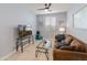 Living room with a TV, ceiling fan, and comfortable brown sofa at 24638 N 144Th Ave, Surprise, AZ 85387