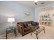 Spacious living room featuring a comfortable sofa, glass table, and ceiling fan at 24638 N 144Th Ave, Surprise, AZ 85387