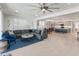 Spacious living room with an open floor plan, modern decor, and seamless access to the kitchen at 24638 N 144Th Ave, Surprise, AZ 85387