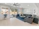 Bright living room featuring a large sectional sofa, stylish decor, and access to outdoor living at 24638 N 144Th Ave, Surprise, AZ 85387