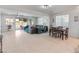 Open-concept living room with a dining area, comfortable seating, and access to the outdoor pool at 24638 N 144Th Ave, Surprise, AZ 85387