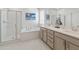 Luxurious main bathroom with dual sinks, a soaking tub, a separate shower, and stylish, modern fixtures at 24638 N 144Th Ave, Surprise, AZ 85387