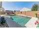 Beautiful swimming pool with lush landscaping, patio furniture, and a serene backyard setting at 24638 N 144Th Ave, Surprise, AZ 85387